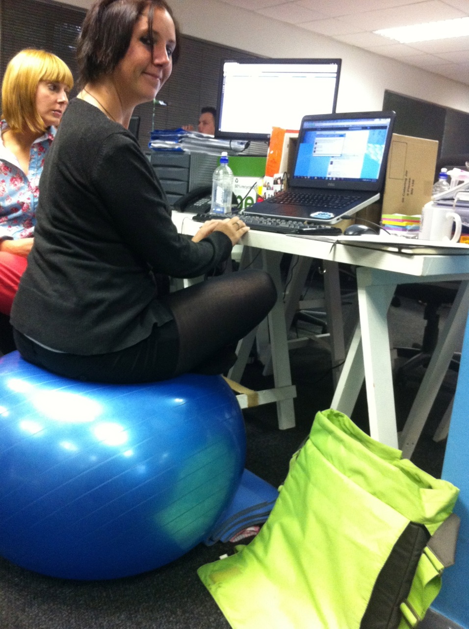 sitting on medicine ball at desk